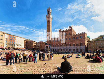 Siena, Italy - October 19, 2016: Tourists at Torre del Magnia Tower Piazza Campo Square Siena, Tuscany, Italy Stock Photo