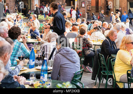 Siena, Italy - October 19, 2016: Tourists in the street cafe on Piazza del Campo square in Siena, Tuscany, Italy Stock Photo
