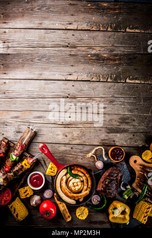 Assortment various barbecue food grill meat, bbq party fest - shish kebab, sausages, grilled meat fillet, fresh vegetables, sauces, spices, on old woo Stock Photo
