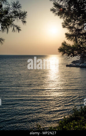 Beautiful sunset view on sea and Stadi Grad - old town of Ulcinj at twilight scene. Coast of Adriatic sea. Montenegro. Stock Photo