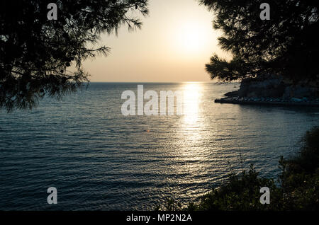 Beautiful sunset view on sea and Stadi Grad - old town of Ulcinj at twilight scene. Coast of Adriatic sea. Montenegro. Stock Photo