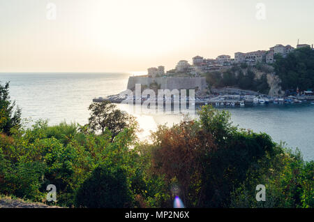 Beautiful sunset view on sea and Stadi Grad - old town of Ulcinj at twilight scene. Coast of Adriatic sea. Montenegro. Stock Photo