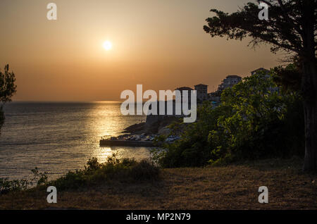 Beautiful sunset view on sea and Stadi Grad - old town of Ulcinj at twilight scene. Coast of Adriatic sea. Montenegro. Stock Photo