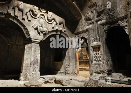 Chapel with burial chamber of Prince Papaq Proshian and his wife (family coat of arms carved in rock above arches), Geghard Monastery (Monastery of th Stock Photo