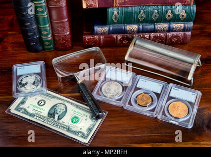 Coin collection with on table with literature. Stock Photo