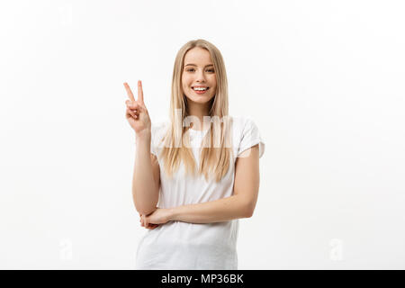 Closeup portrait young happy confident woman giving peace victory, two sign gesture, isolated white studio background. Positive emotion facial expression feelings symbols, attitude Stock Photo
