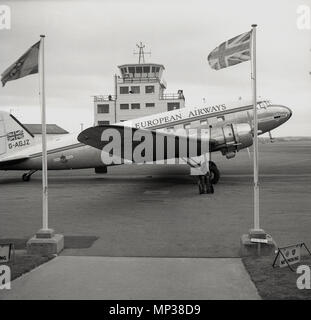 1950s, A Douglas C-47A (DC-3) Skytrain of the airline, Briitsh European Airways parked on a runway outside the entrance to a small european airport, possibly West Berlin in Germany. In the 1960s the Briitsh airline became the fifth biggest passenger-carrying airline in the Western World. The plane shown, built in 1943, was former RAF plane, and was converted by scottish aviation and named RMA John Stringfellow after an early British aviator. It served BEA from 1946 to 1960. Stock Photo