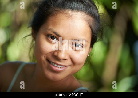 Attractive hispanic girl portrait close-up on blurred natural nbackground Stock Photo