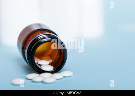 Pills spilling out of pill bottle Stock Photo