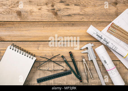 Architect workplace top view. Project construction blueprints and engineering tools on wooden desk, copy space Stock Photo