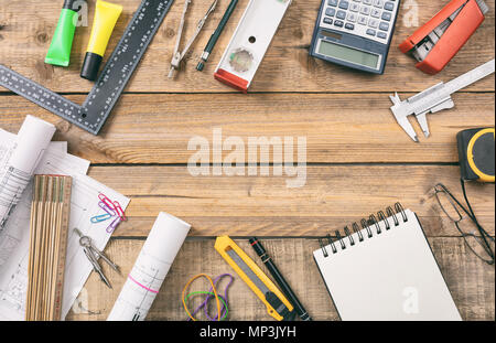 Project construction site. Hand tools, blueprints and engineering equipment on a wooden desk, copy space, top view Stock Photo