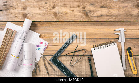 Architect workplace top view. Project construction blueprints and engineering tools on wooden desk, copy space Stock Photo