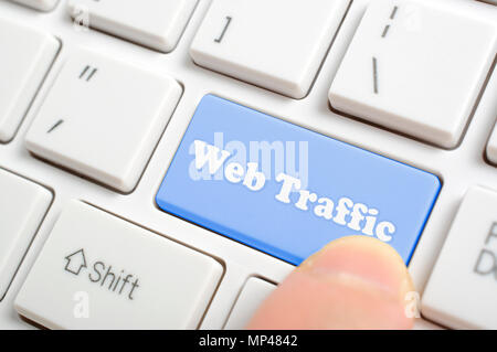 Pressing blue web traffic key on keyboard Stock Photo