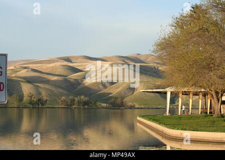 Fisherman under the shed, late afternoon in the spring, near Ming Lake, Bakersfield, Kern County, CA. Stock Photo