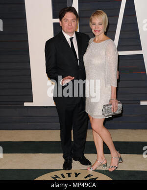 Mike Myers and wife Kelly Tisdale walking on the red carpet at the 91st