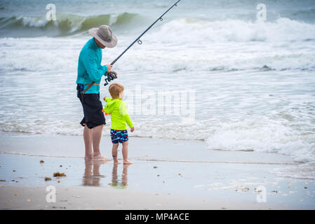 Father and son enjoying time at the beach together surf fishing in Ponte Vedra Beach near Jacksonville, Florida. (USA) Stock Photo