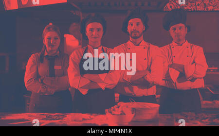 Portrait of group chefs standing together in commercial kitchen at restaurant Stock Photo