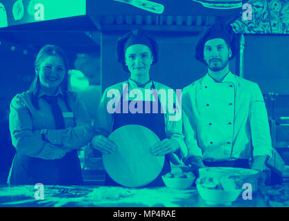 Portrait of group chefs standing together in commercial kitchen at restaurant Stock Photo