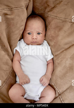 A three week old baby boy looking at the camera Stock Photo