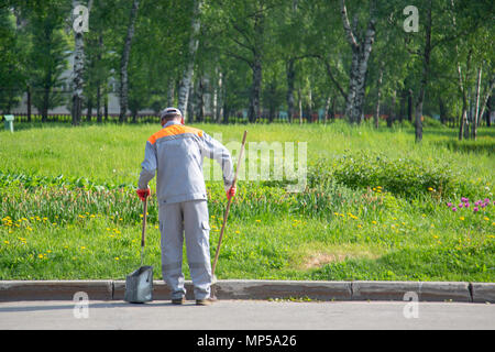 Selective focus road Sweeper cleaning walkway in the public park,copy space.l Stock Photo