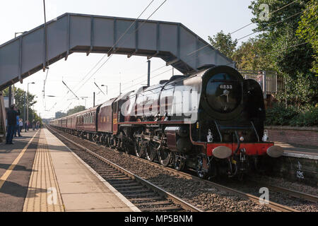 Ex LMS Steam locomotive Duchess of Sutherland No. 6233 passes Chester le Street station on the east coast main line, north east England, UK Stock Photo