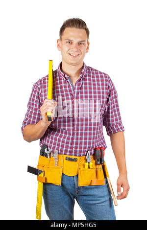 Young repairman holding a spirit level, smiling to the camera on isolated background Stock Photo
