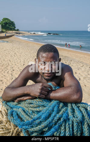Portrait of African man fishing on river and putting caught fish in bucket  Stock Photo - Alamy