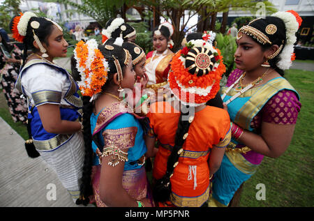 Students from Springwood High School, Kings Lynn, gather together after performing traditional southern Indian dance in front of the Iron Garden in the Great Pavilion during the press day for this year's RHS Chelsea Flower Show at the Royal Hospital Chelsea, London. Stock Photo