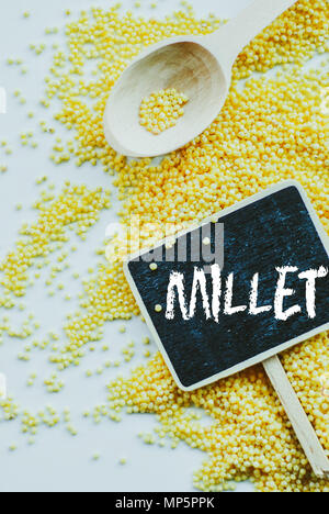 organic millet seeds and chalkboard with word millet on white background Stock Photo