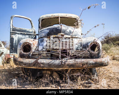 Abandoned classic car rusting in Namib desert, Namibia Stock Photo