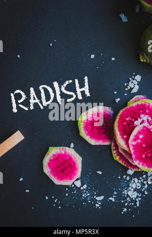 Watermelon Radishes Sliced, Sprinkled with Sea Salt on a black background Stock Photo