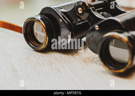 Vintage binoculars on a wooden background Stock Photo