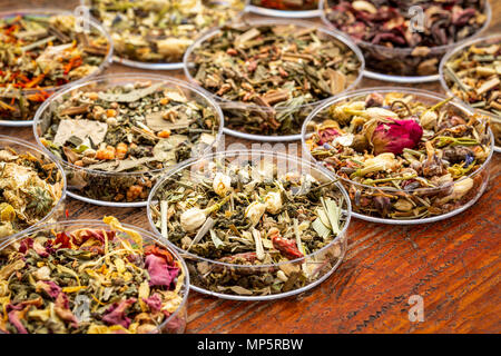 Chinese herbal tea sampler collection - round bowls (Petri dish) on a rustic wood Stock Photo