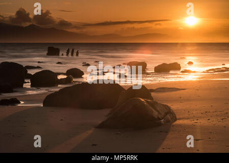 Old Shipwreck near Ardrossan beach in the Scottish Highlands looking towards the Isle of Arran, Scotland, UK Stock Photo