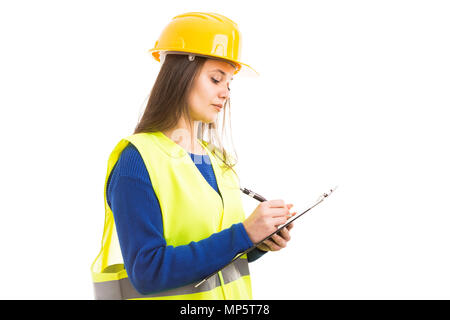 Young female engineer or architect writing on clipboard as busy working supervisor concept isolated on white background Stock Photo