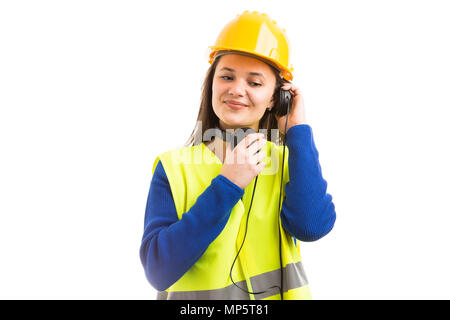 Young female engineer or architect listening to music in headphones as relaxing work break concept isolated on white background Stock Photo