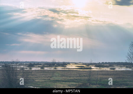 The sun shines through the rain clouds Stock Photo