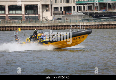 Passengers enjoy a speed boat trip on the River Thames in London, UK. Thames RIB Experience is one of several companies offering fast Rib trips Stock Photo