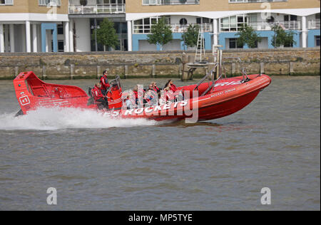 Passengers enjoy a speed boat trip on the River Thames in London, UK. Thames Rockets is one of several companies offering fast Rib trips Stock Photo
