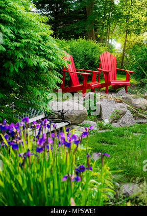 Empty outdoor Adirondack lawn chairs along the waterfront and beach