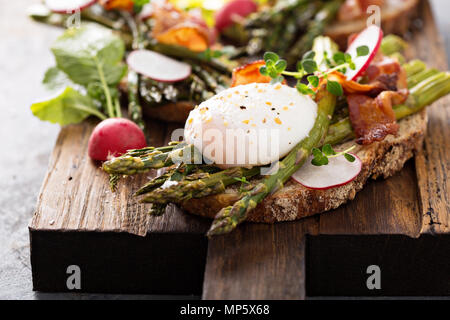 Asparagus and bacon bruschetta with poached egg Stock Photo