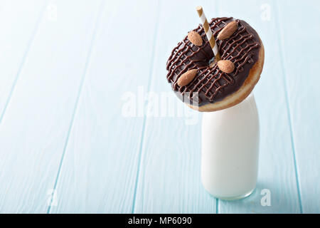 Chocolate almond donut with a bottle of milk Stock Photo