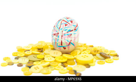 isolated happy easter, colorful easter egg standing on the yellow button, easter holiday decorations, easter concept backgrounds Stock Photo