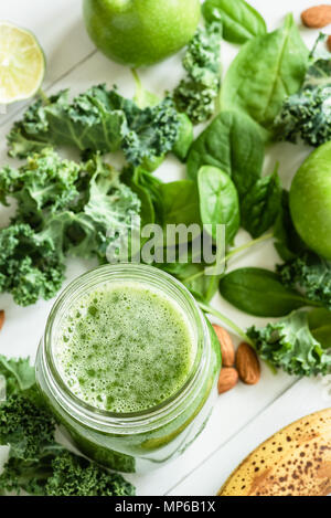 Green Detox Smoothie or Juice in bottle jar. Fresh summer detox drink with kale, broccoli, apple, spinach and lime. Top view Stock Photo
