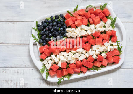 Patriotic American flag salad with blueberry, watermelon and feta on arugula Stock Photo