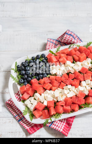 Patriotic American flag salad with blueberry, watermelon and feta on arugula Stock Photo