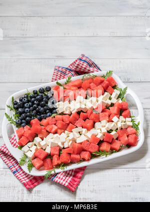 Patriotic American flag salad with blueberry, watermelon and feta on arugula Stock Photo