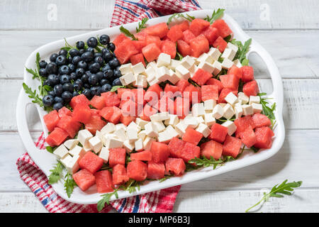 Patriotic American flag salad with blueberry, watermelon and feta on arugula Stock Photo