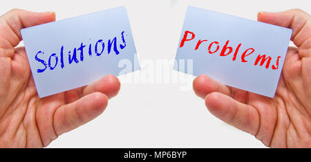 man hands holding cards with the words problems and solutions Stock Photo