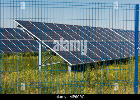 Grin clean electric power - Solar panel outside on grass field photo-voltaic Stock Photo